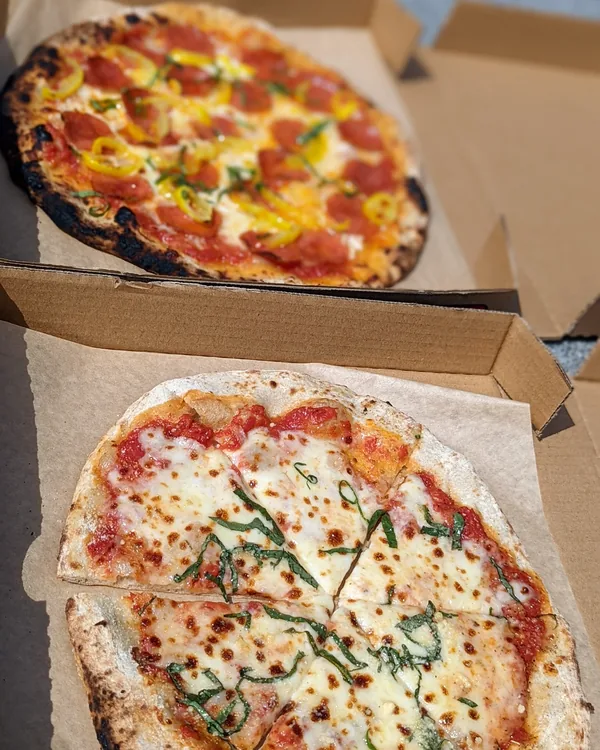 Catering pizzas boxed in pairs